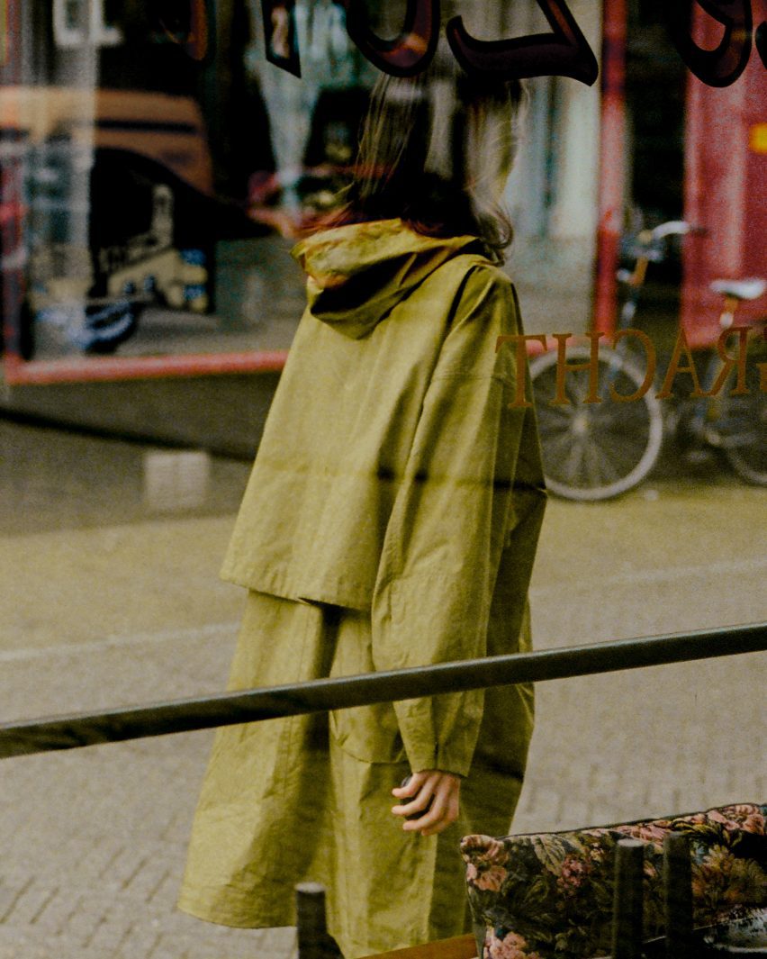 Photo of a woman looking forwards and walking while holding the Terra device in one hand