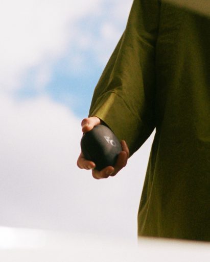 Person holding screen-less AI compass by Panter & Tourron and Modem Works Design