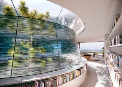 A glass courtyard wrapped around a tree