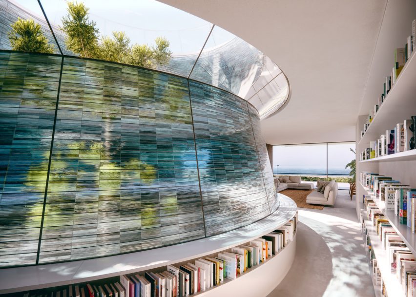 A glass courtyard wrapped around a tree