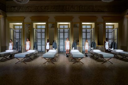 Six models wearing underwear stood beside their respective beds