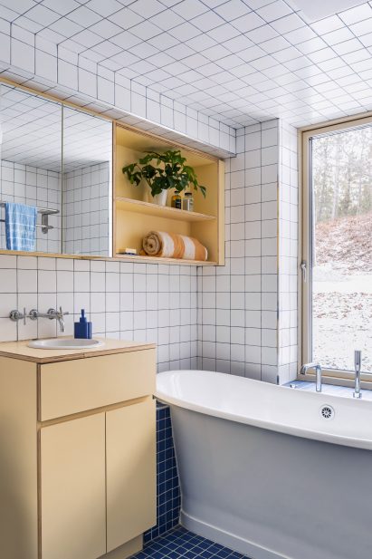White bathtub in bathroom with tiles