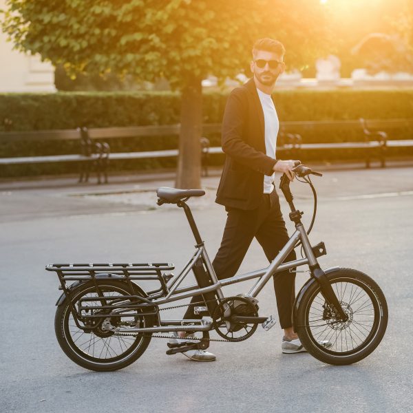 a man walking with a bike of modern design