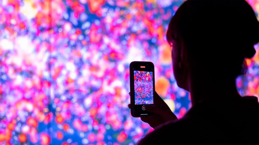 Photo of a person taking a photo at the Biophilia exhibition at Denver Art Museum