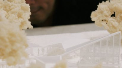 Closeup of architect Minsuk Cho and his model of Serpentine Pavilion 2024