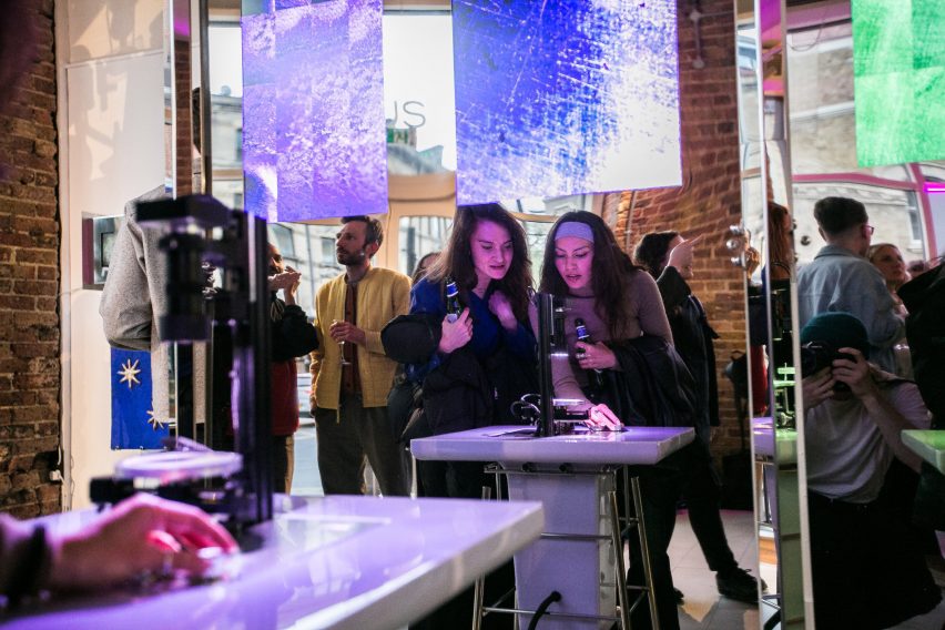 Two people looking at a microscope