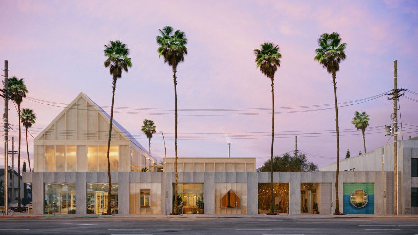 Photo of building and palm trees with a purple sky