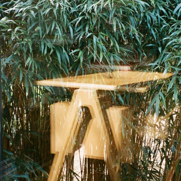 Blurry photo of a wooden table by &Tradition