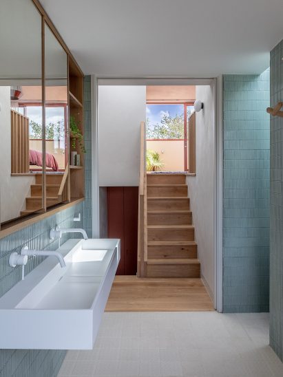 Blue-tiled bathroom of Aden Grove by Emil Eve Architects