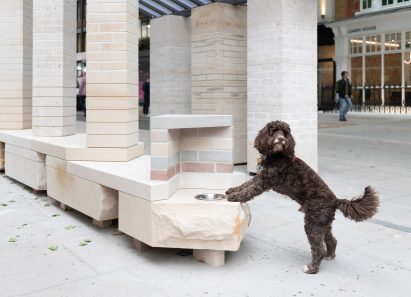 Dog next to a stone brick installation
