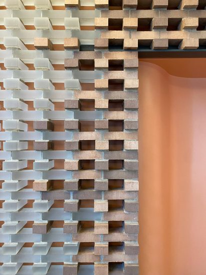 Detail of part of the wall showing red bricks and glass bricks laid together