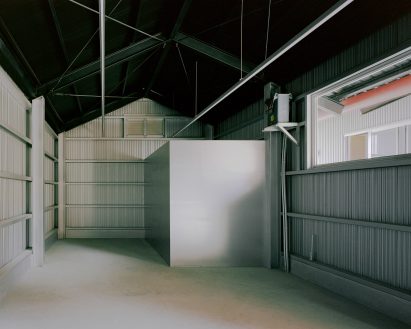 Storage space within metal home by Studio Tngtetshiu