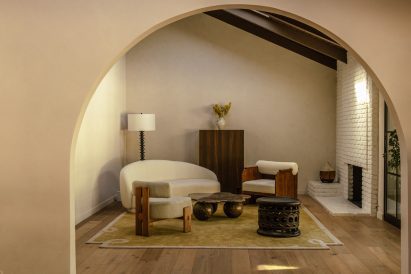 Formal living room with sculptural seats arranged around a marble coffee table