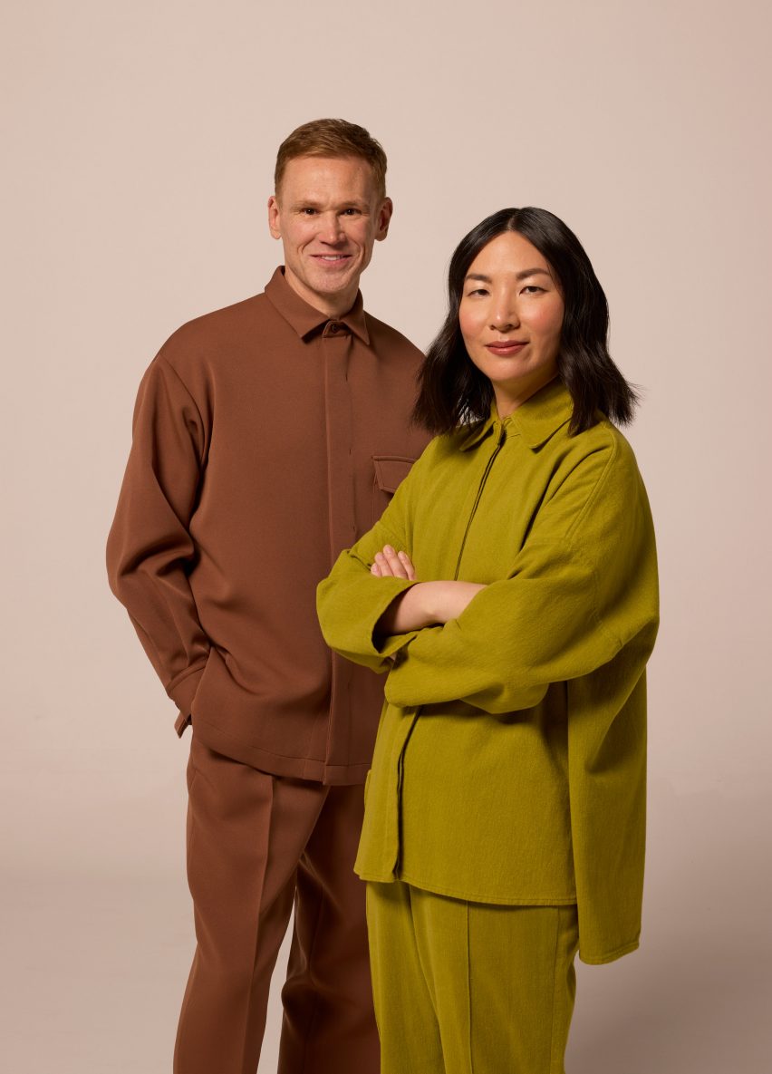 Two people standing next to one another