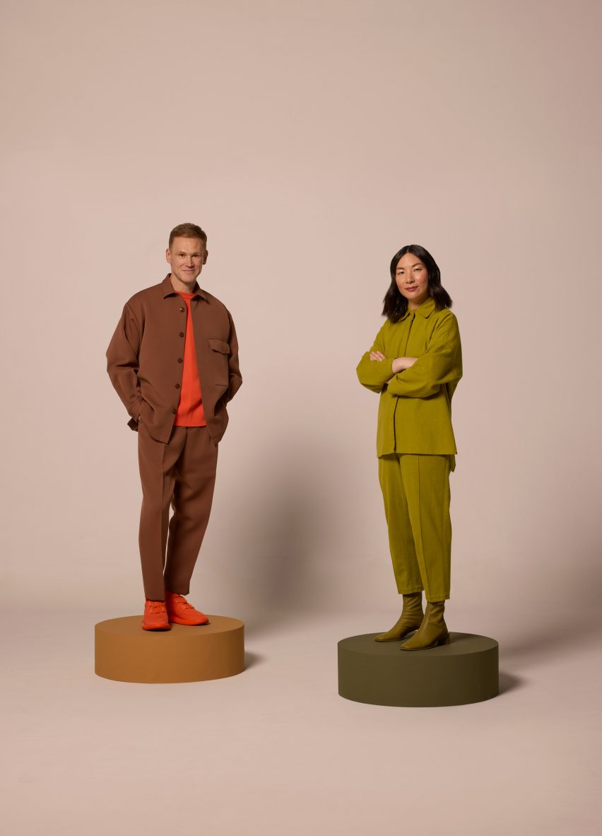 Two people standing next to one another