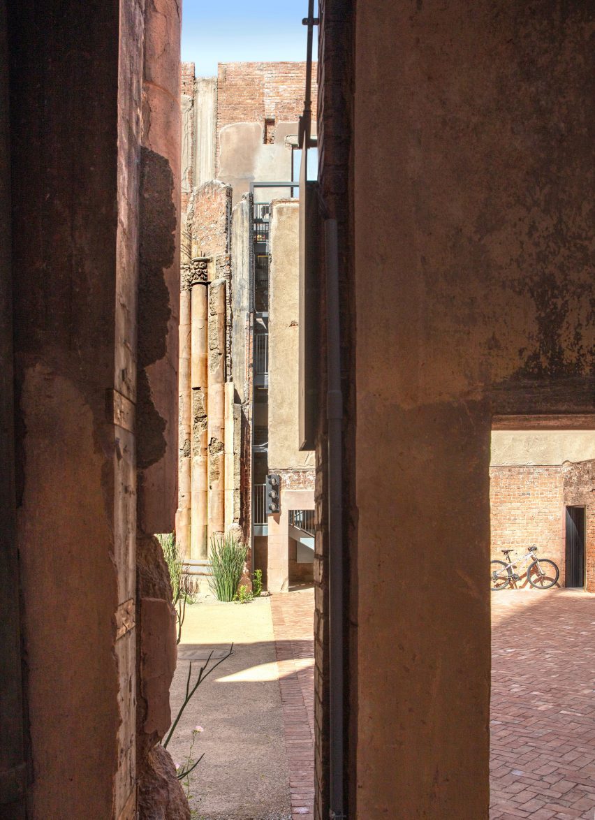 View looking past wall into a courtyard