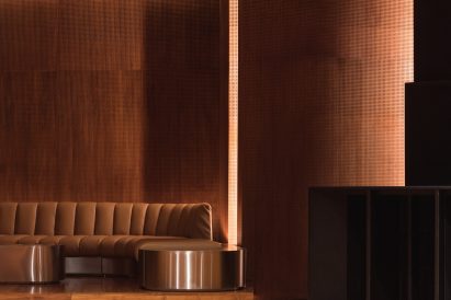 Built-in leather seats match warm brown tones of wood panelling