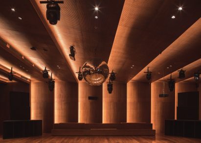 A disco ball measuring one metre in diameter hangs over a sprung dance floor