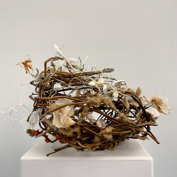 Nest-like structure on white plinth