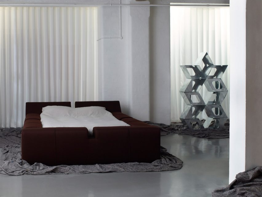 Large bed and metal sculpture at London design exhibition