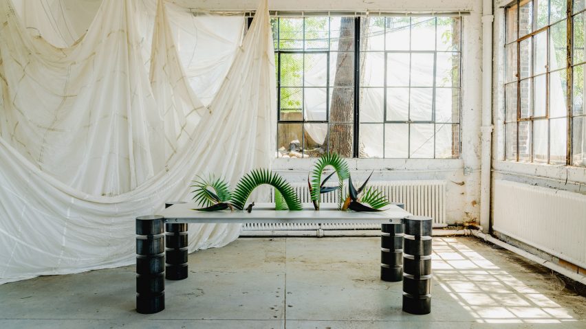 A table in a room with large windows