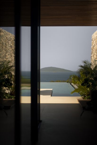 View from inside bungalow out to swimming pool and sea
