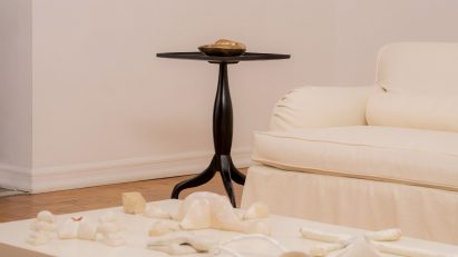 Clay objects on table in front of coucn