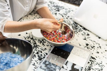 Plastic pieces being prepared for pressing
