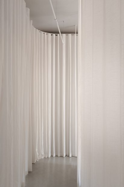 White curtain curving around corner