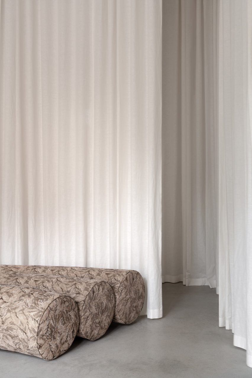 White curtain with curving sofa