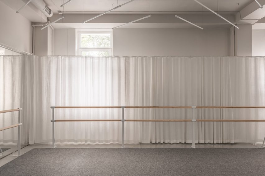 A ballet bar in front of curtains