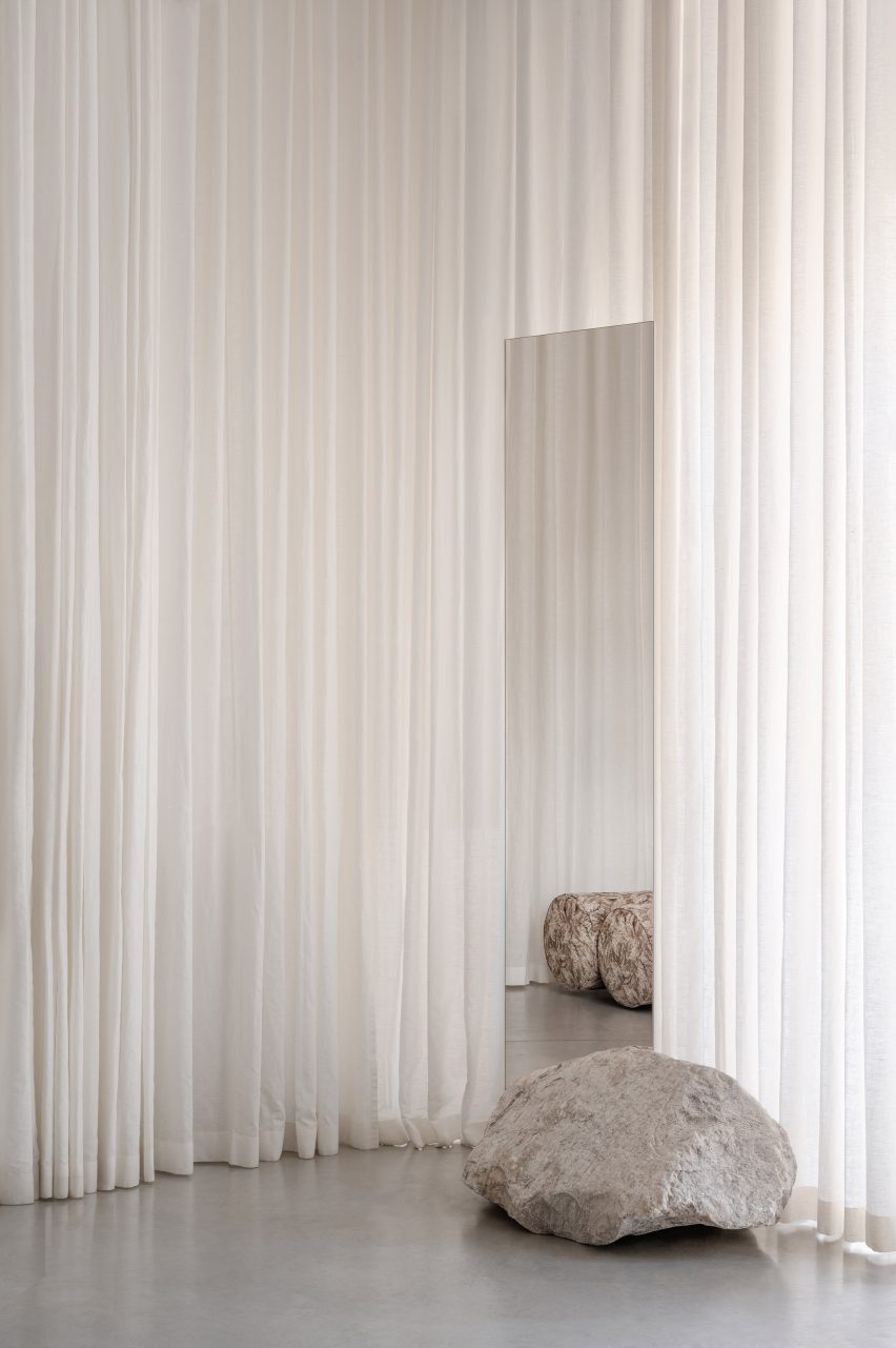 A mirror in front of curtains