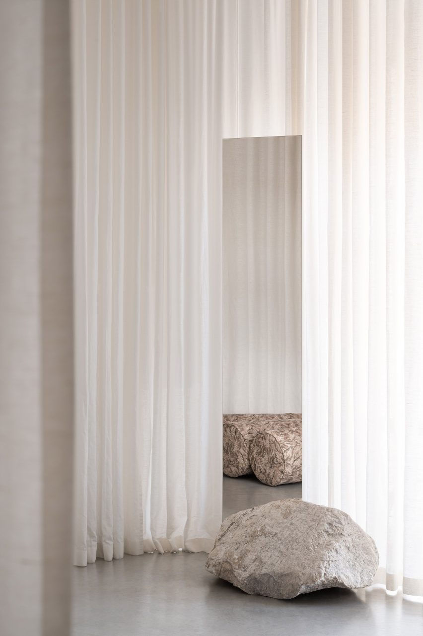White curtains with boulder