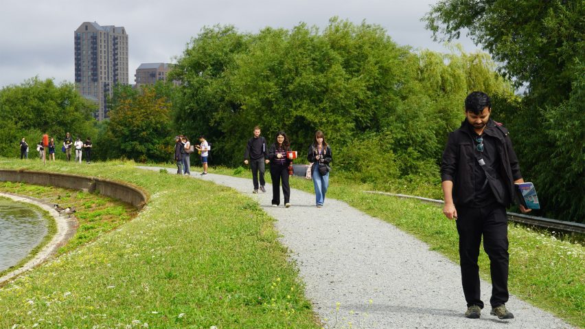 A photograph of people walking alongside a canal