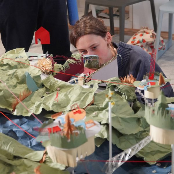 A photograph of a student interacting with a design piece