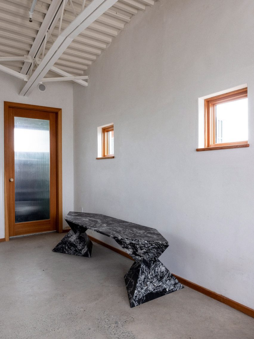 A bench in front of windows