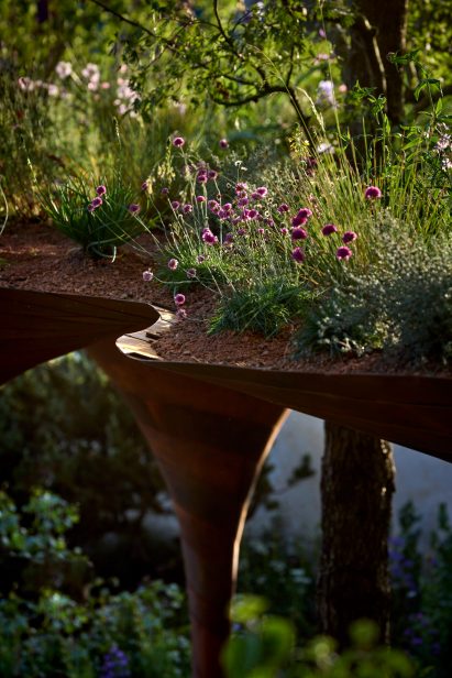 Flowers planted on roof of weathering-steel pavilion