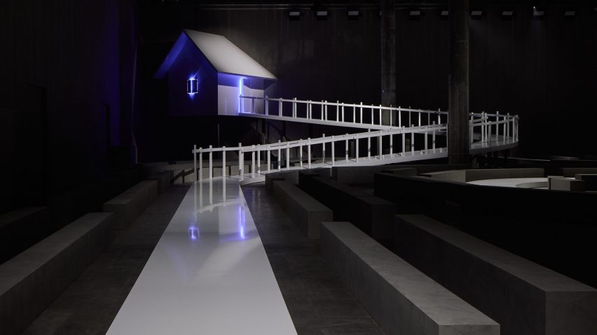House on catwalk lit by purple light
