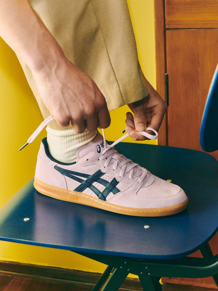 Pale pink trainer being tied