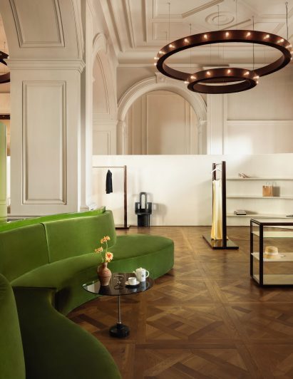 Bronze chandeliers and green sofa inside Boygars Tbilisi