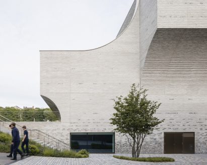 Building elevation clad in grey brick and flint