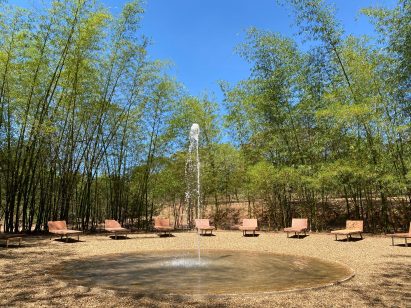 Stone chaise lounges around fountain