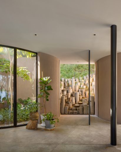 A series of cylindrical pillars form a staircase into a living room