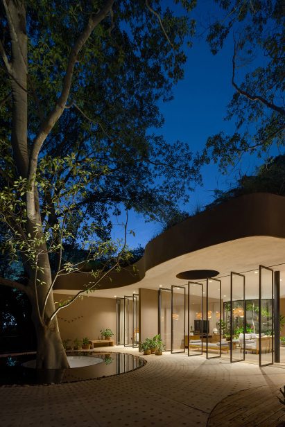 Night view of building exterior with open window panels