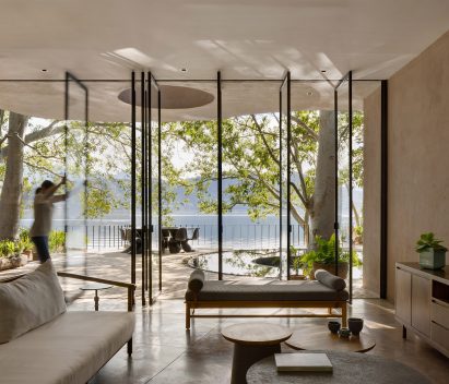 Glass panels facing a lake pivot and slide open