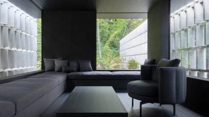 Angled concrete blocks screen home in Japanese forest by Nendo