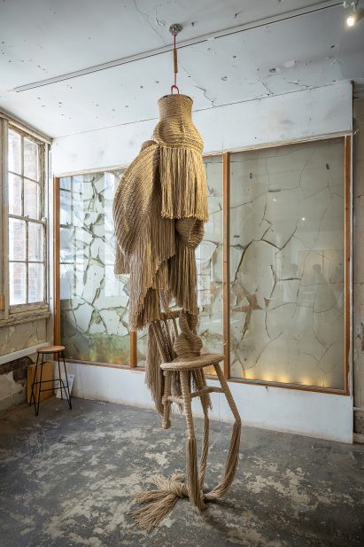 Photo of Christopher Kelly's Interwoven: Dis/functional No.1 textile sculpture hanging from a ceiling and dragging on the floor