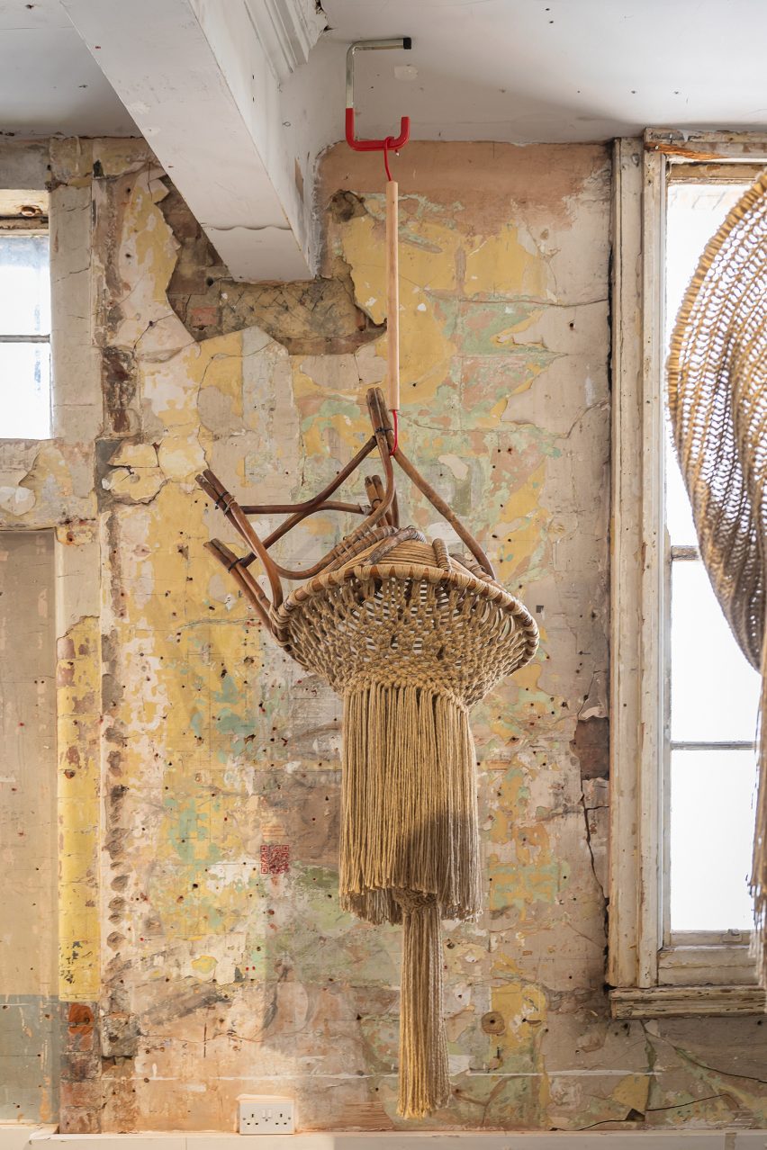 Photo of Christopher Kelly's Interwoven: Dis/Functional No.2 sculpture hanging from a ceiling and showing a chair frame merging with a corcheted and tasselled jute form