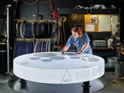 A skilled technician tracing a part template for optimized glass utilization on a boule of Corning HPFS Fused Silica.