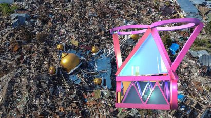 Visualisation of an architectural structure in tones of pink and blue amongst waste rubble in colours of brown and grey.
